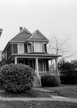 Black and white archival photograph of the previous depicted home. Showing little to no change in its original design.