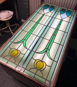 2 stained glass panels on a light table